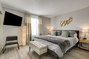 Master bedroom with a king bed, 50" 4K Roku TV with cable TV.