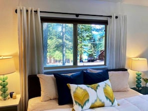 Master bedroom sunrise lake views. Plush king mattress, linens, USB outlets, and blackout curtains.