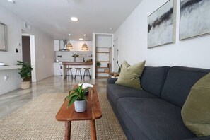 Kick back in the inviting living room, complete with open shelving and thoughtful design accents.