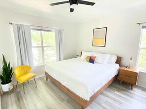 Wake up to sunlight in this airy bedroom with a plush bed, calming decor, and peaceful vibes.