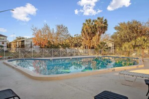 Relax by the sparkling pool surrounded by lush greenery—perfect for lounging, swimming, or soaking up the Florida sunshine.