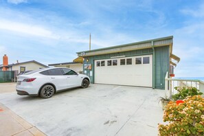 parking space where white car is parked to the left of the garage on top
