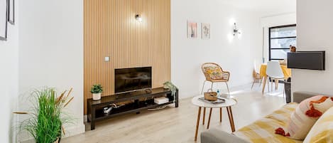 This bright living room has a comfortable sofa and a dining table bathed in natural light #bright #naturallight #portugal #algarve #carvoeiro