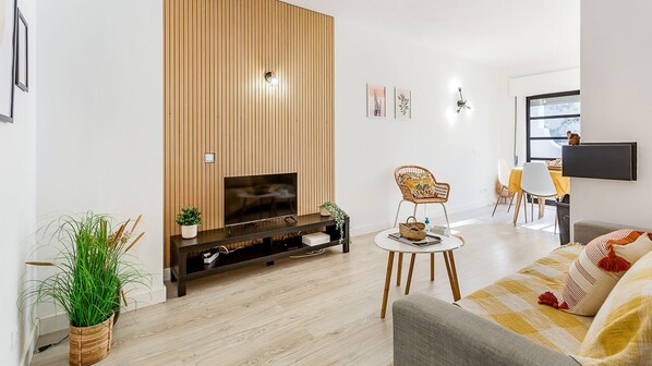 This bright living room has a comfortable sofa and a dining table bathed in natural light #bright #naturallight #portugal #algarve #carvoeiro