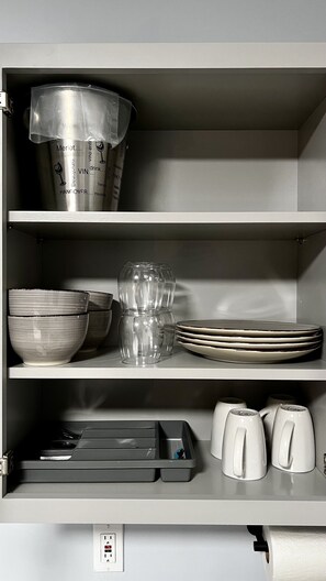 cups, plates, bowls, utensils, ice bucket, bottle opener and paper towel roll