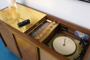 An original MCM turntable console that is wired to stream tunes using Bluetooth.