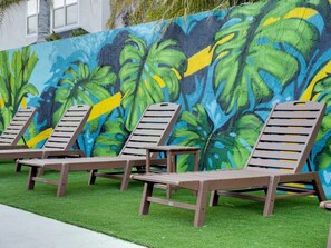 Picture yourself sunbathing by the pool in front of our beautiful mural