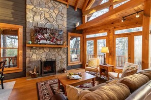 Wall of Windows, Stone Wood-Burning Fireplace and High Vaulted Ceilings in the Living Room