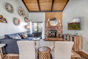 Living Room with Natural Light and High Wood Beam Ceilings