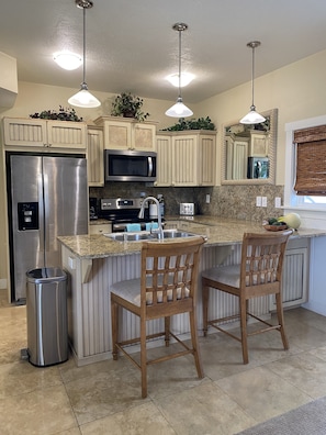 Gourmet kitchen with flat top range and full size fridge
