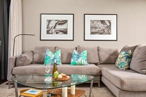 Sip and snack in style on this plush sectional, framed by striking monochrome art and glowing natural light PKC-404