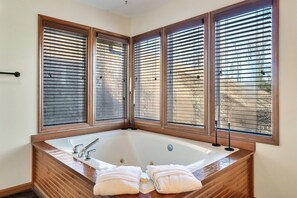 Enjoy the luxury of your own en suite master bathroom with your own jacuzzi tub! Take a soak, and then wrap up in a cozy robe for that ultimate relaxation experience.