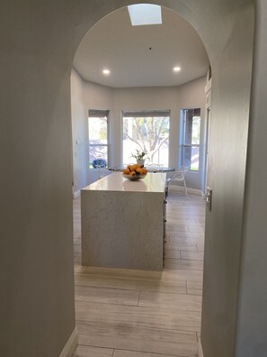 Beautiful arches leading into high ceiling chef's kitchen
