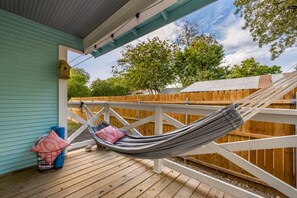 Relax on our back porch hammock! Private enclosed fence for plenty of privacy.
