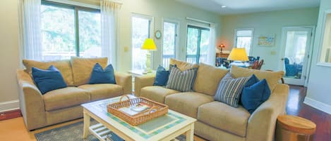 The living room opens onto the dining area and sunroom.