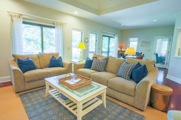 The living room opens onto the dining area and sunroom.