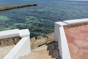 Stairs to clear blue water