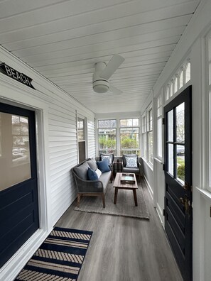 Enclosed front porch with heater, blue tooth speaker, fan and shades for privacy