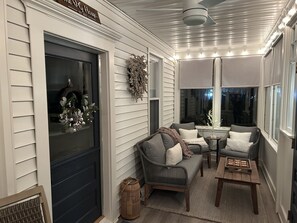 Enclosed front porch with heater, blue tooth speaker, fan and shades for privacy