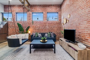 Living area with exposed brick and beams