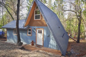 Cozy A-frame cabin front of the house