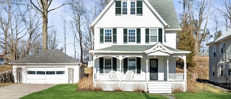 Charming home with 2 car garage 1 block from the village. 