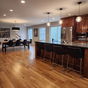 Large open kitchen & dining area has lots of comfortable seating.