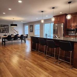 Large open kitchen & dining area has lots of comfortable seating.