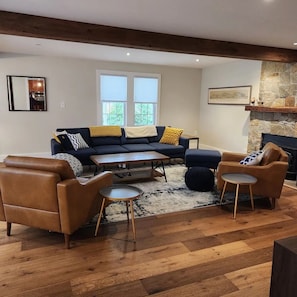 Sunny and inviting, wood-beamed living room.