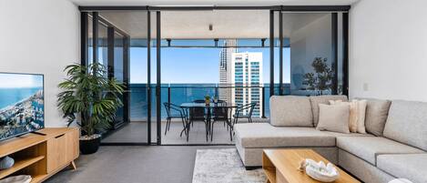 Living area is right next to the blacony overlooking the ocean and the city