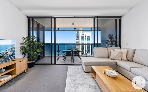 Living area is right next to the blacony overlooking the ocean and the city