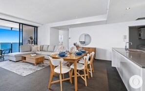 Dining area is right next to the living area overlooking the ocean and the city