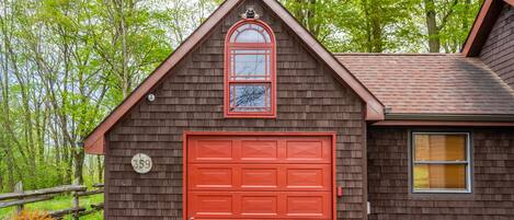 The striking red of the garage and accents of the home make Aquila Casa stand out.