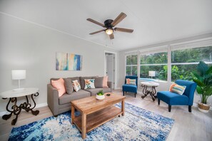 Relax in a cozy living room with sofa, chairs, table