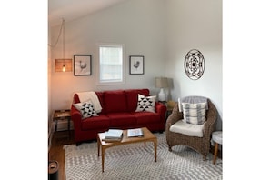 Couch pulls out for additional sleeping space with feather topper & linens