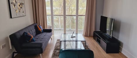 Living room overlooking the balcony with open plan kitchen 