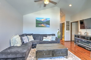 Living room w/ plush sleeper sofa, SmartTV, & hall to bedroom & bathroom