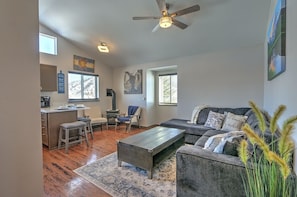 Open living room with sitting area near gas fireplace and plush sleeper sofa