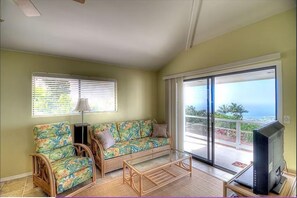 Living room with pull out couch, TV and view of Lanai