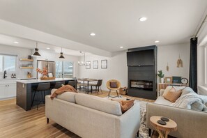 Living room with 55" Roku smart TV and electric fireplace. 