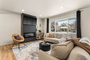 Living room with 55" Roku smart TV and electric fireplace. 