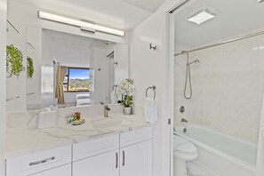 Full bathroom with tub and shower combo.