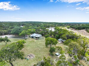 Aerial view of the property showing location of house, hot tub, and fire pit.