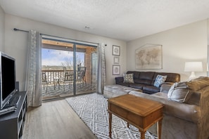 Floor-to-ceiling glass sliding doors in the living area