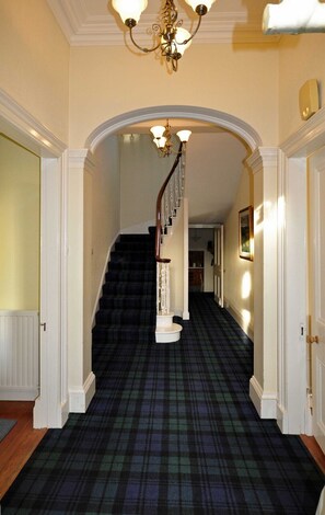 The hallway with tartan carpet
