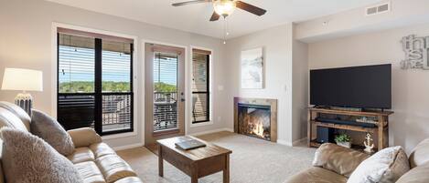 Living Room with Cable TV, Deck Access, and Seasonal Fireplace