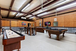 Play pool, shuffleboard or ping pong in the barn while watching the 72-inch Roku TV.