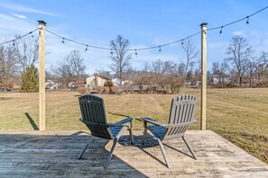 Relax on back deck overlooking quiet lot.