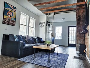 Cozy, comfy couch in the living room facing a 65" flat screen TV.