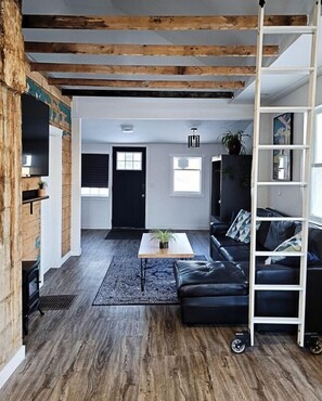 A blend of rustic and modern. We wanted to keep the wood feature wall, exposed beams, and chimney original to showcase the character of this 1940s home!